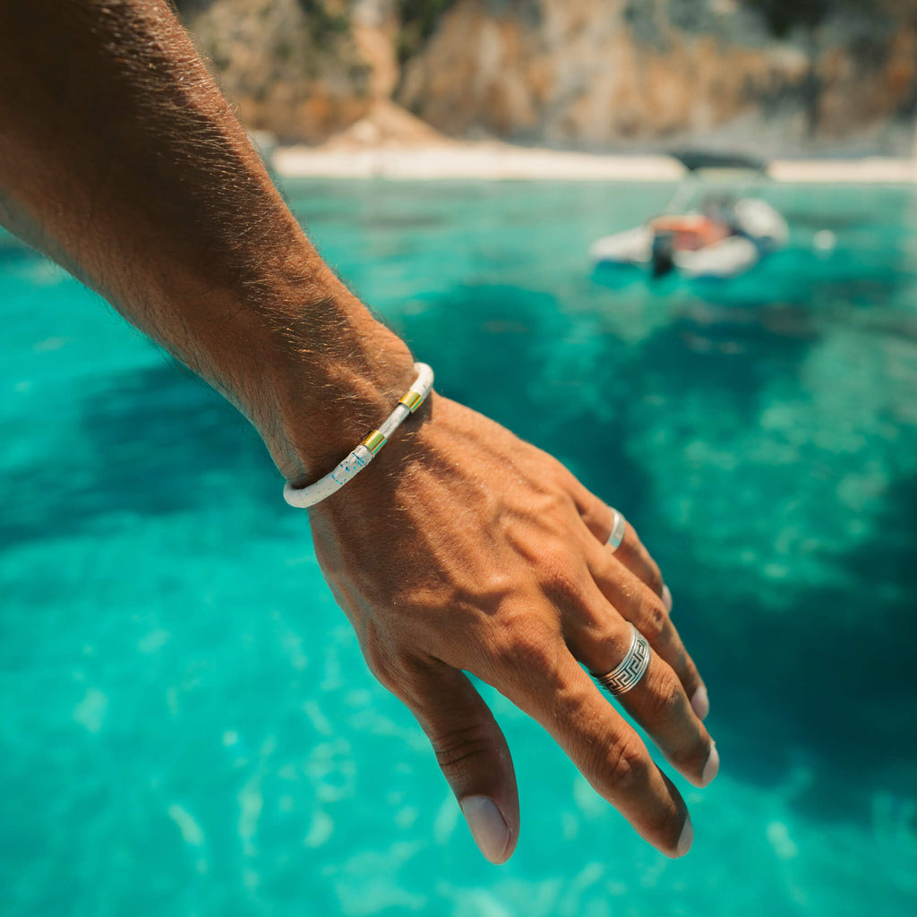 18k gold plated coral legend bracelet close up on a man's wrist